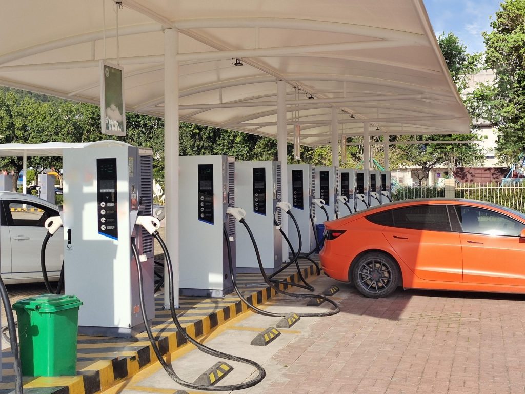 An electric car charging at an electric vehicle fast charging station