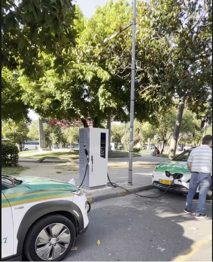 An owner charging his electric car vehicle in moderate temperatures