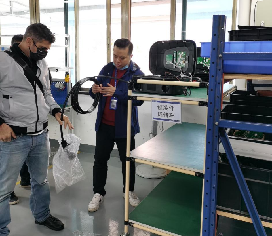 A man replacing a charging cable for a split electric car charger