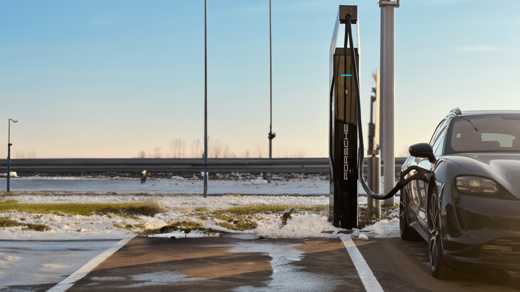 Black car is charging under sunshine